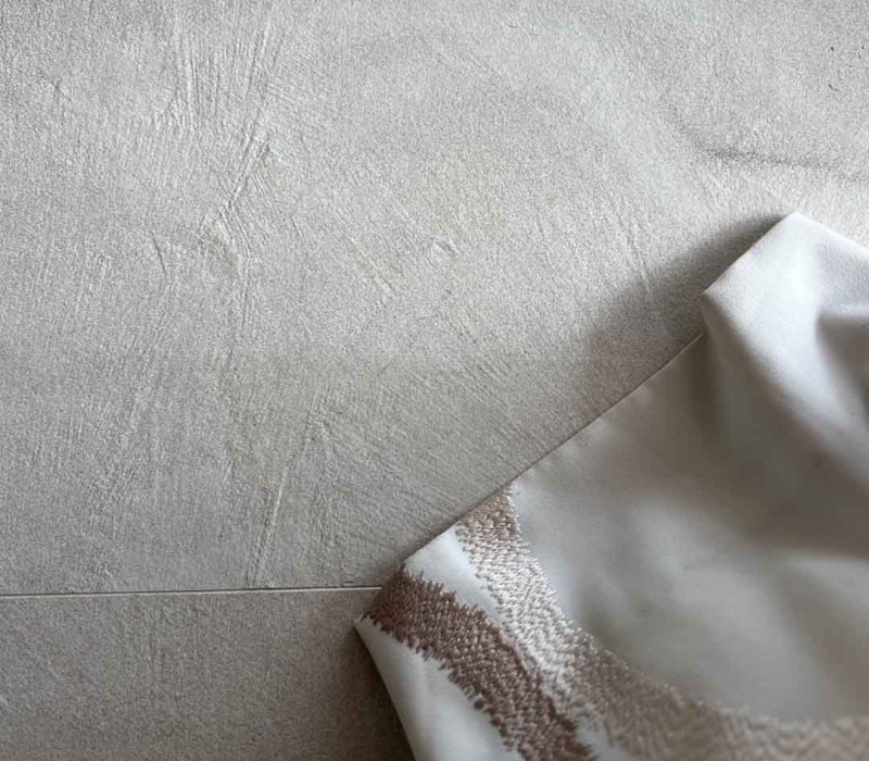 focus sur les details de ce carrelage effet béton clair - sol de salon comtemporain avec oeuvres d'art